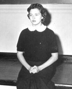 A woman in dark dress sitting in a room