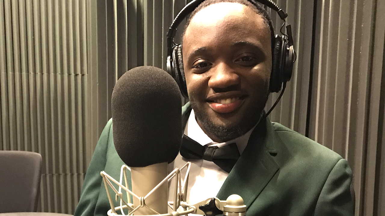 M'Kharis at WFSU in front of a microphone