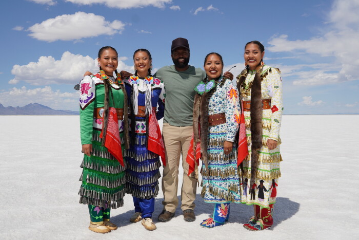 Baratunde poses with the Jingle Dress Dancers in Bonneville Salt Flats State Park in Wendover, Utah. image