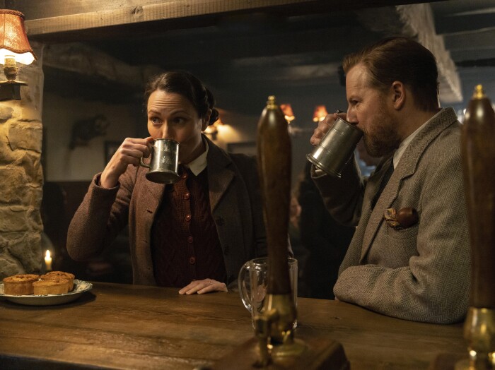 Anna Madeley as Mrs. Hall and Samuel West as Siegfried Farnon having a drink image