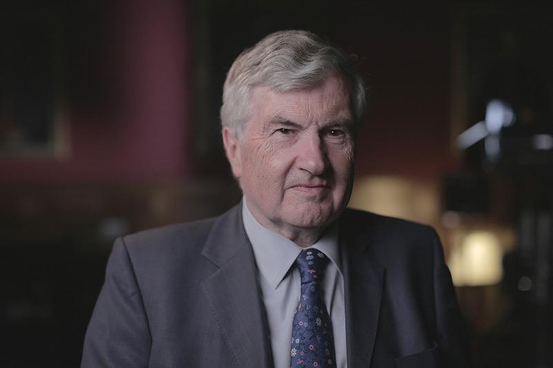 white-haired man in suit image
