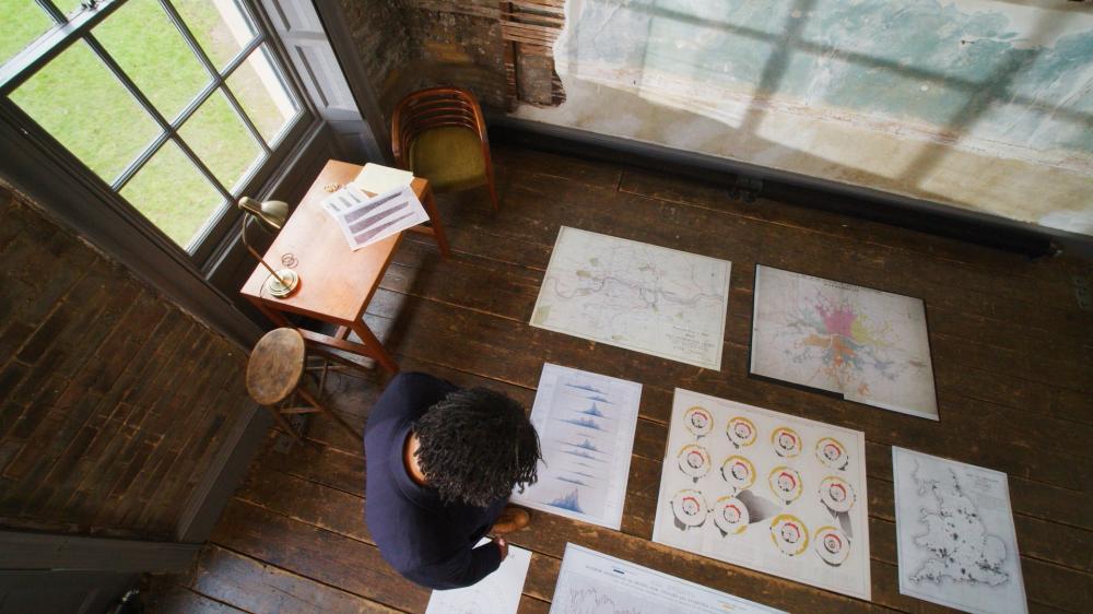 A person looking at paper data