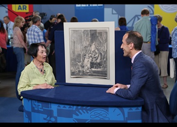 Todd Weyman talking to a woman and appraising a Rembrandt "Christ Before Pilate" etching in Green Bay image