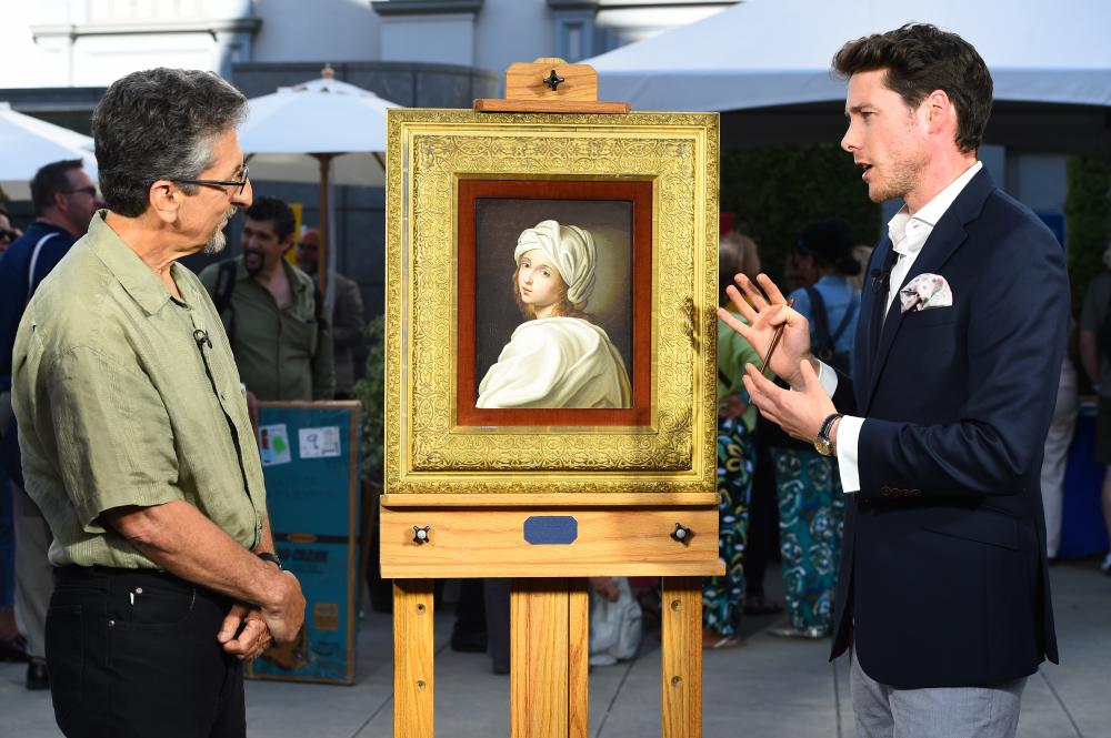 David Walker talks to a man and appraises a Moglia "Beatrice" painting at Crocker Art Museum in Sacramento image