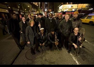group of people with instruments smiling at the camera image