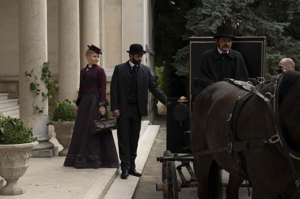 a man and woman leaving a horse carriage image