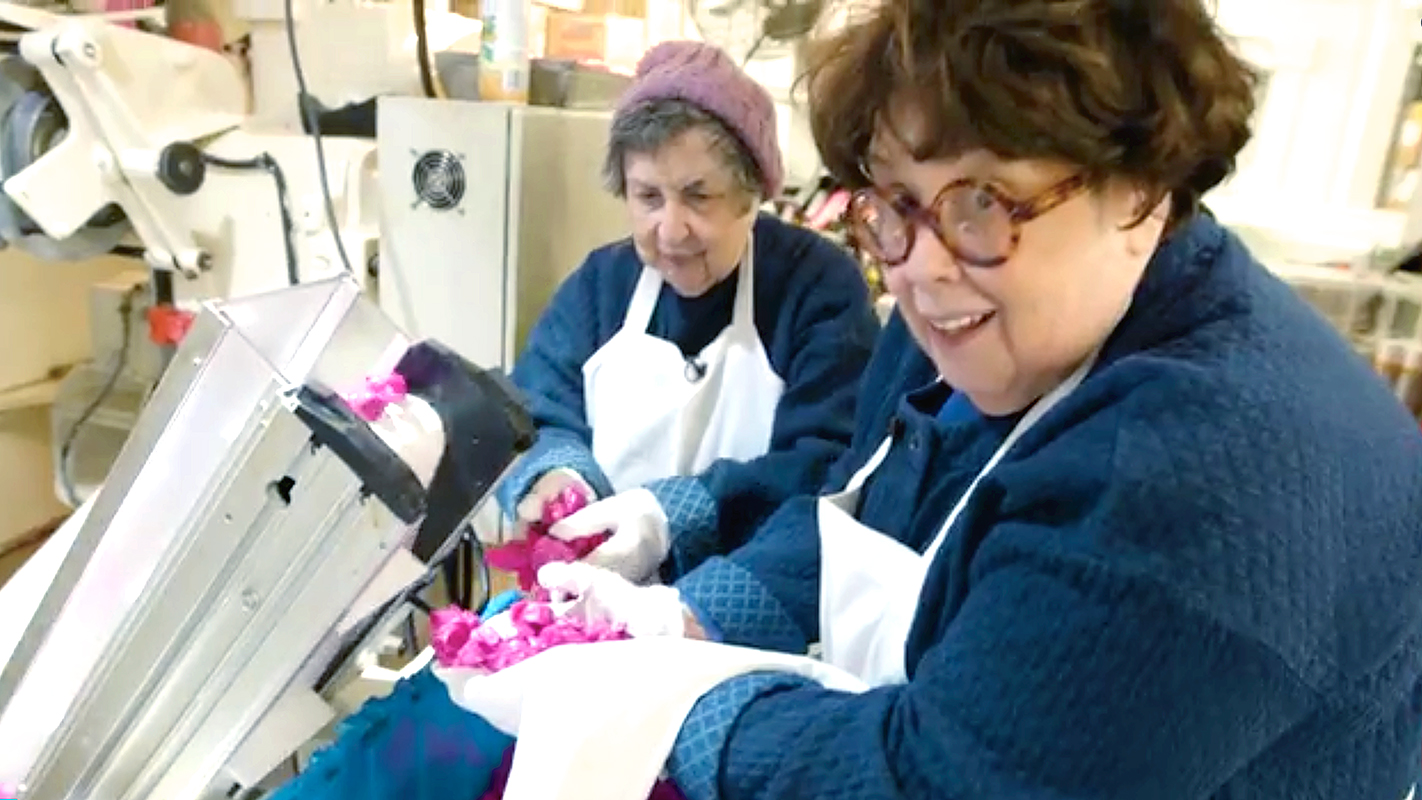 two women with head scarfs cooking