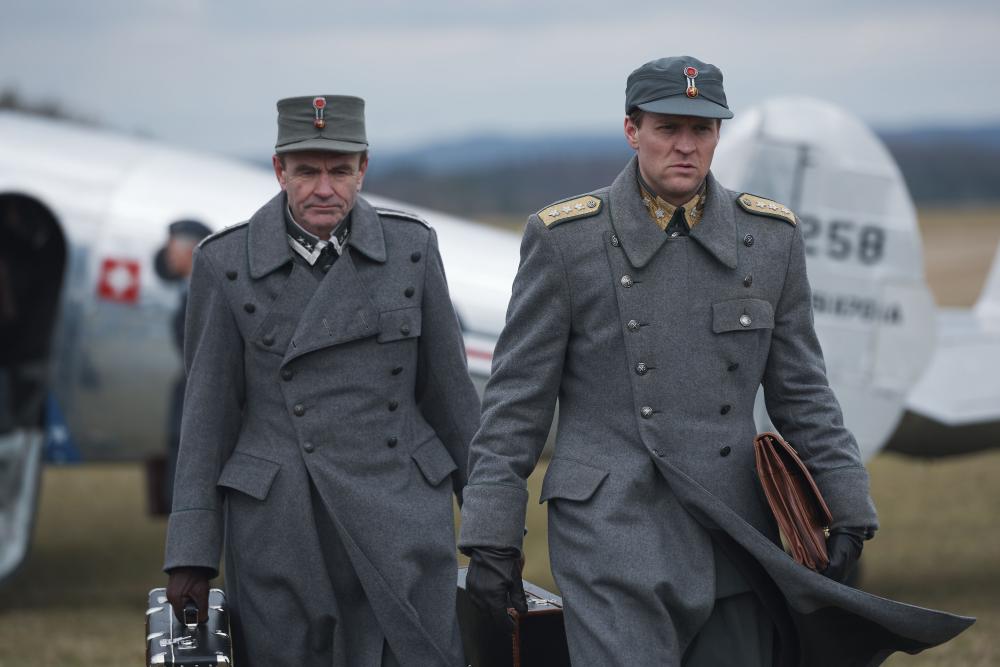Two generals in front of a plane image