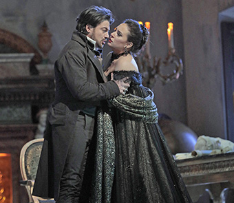 man and woman embracing, dressed in black