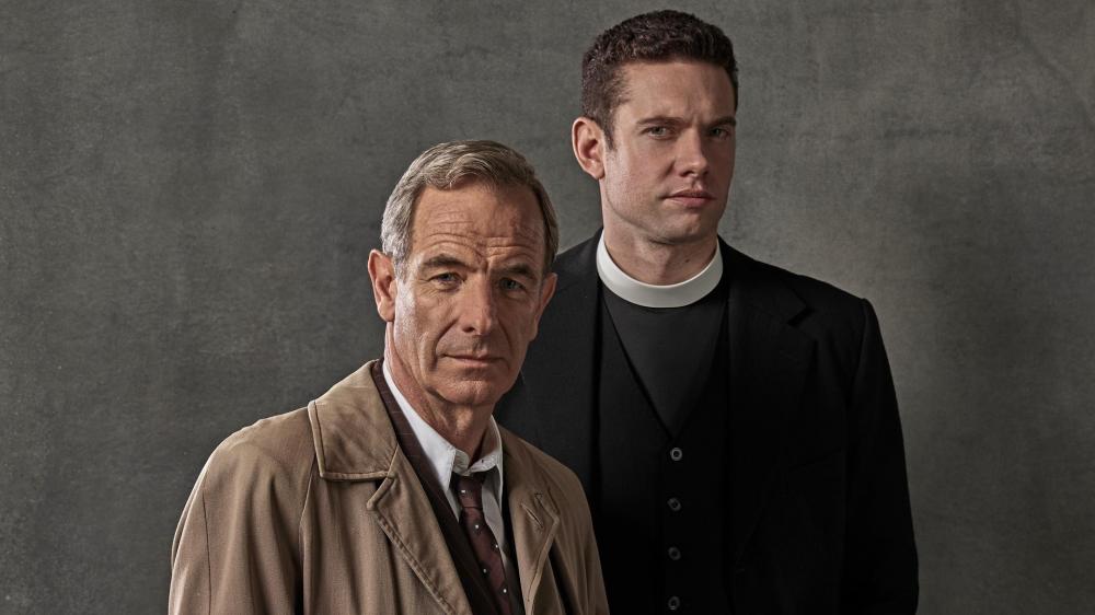 a priest standing next to a man in a trench coat image