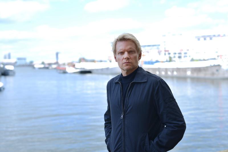 Van der valk standing in front of pier image