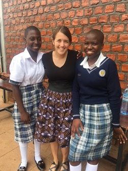 a woman and two children in school uniform