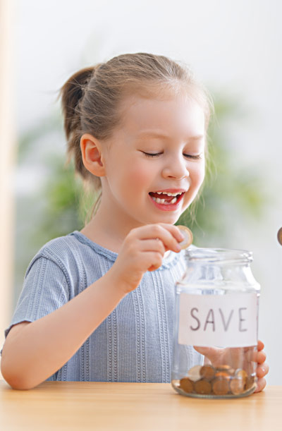 girl with coin jar smiling