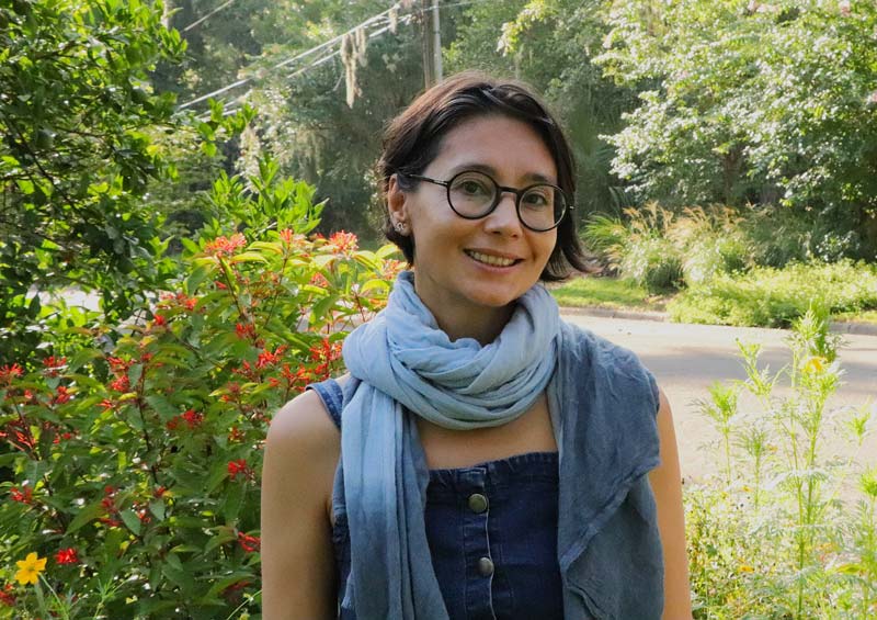 Woman with glasses wearing blue scarf