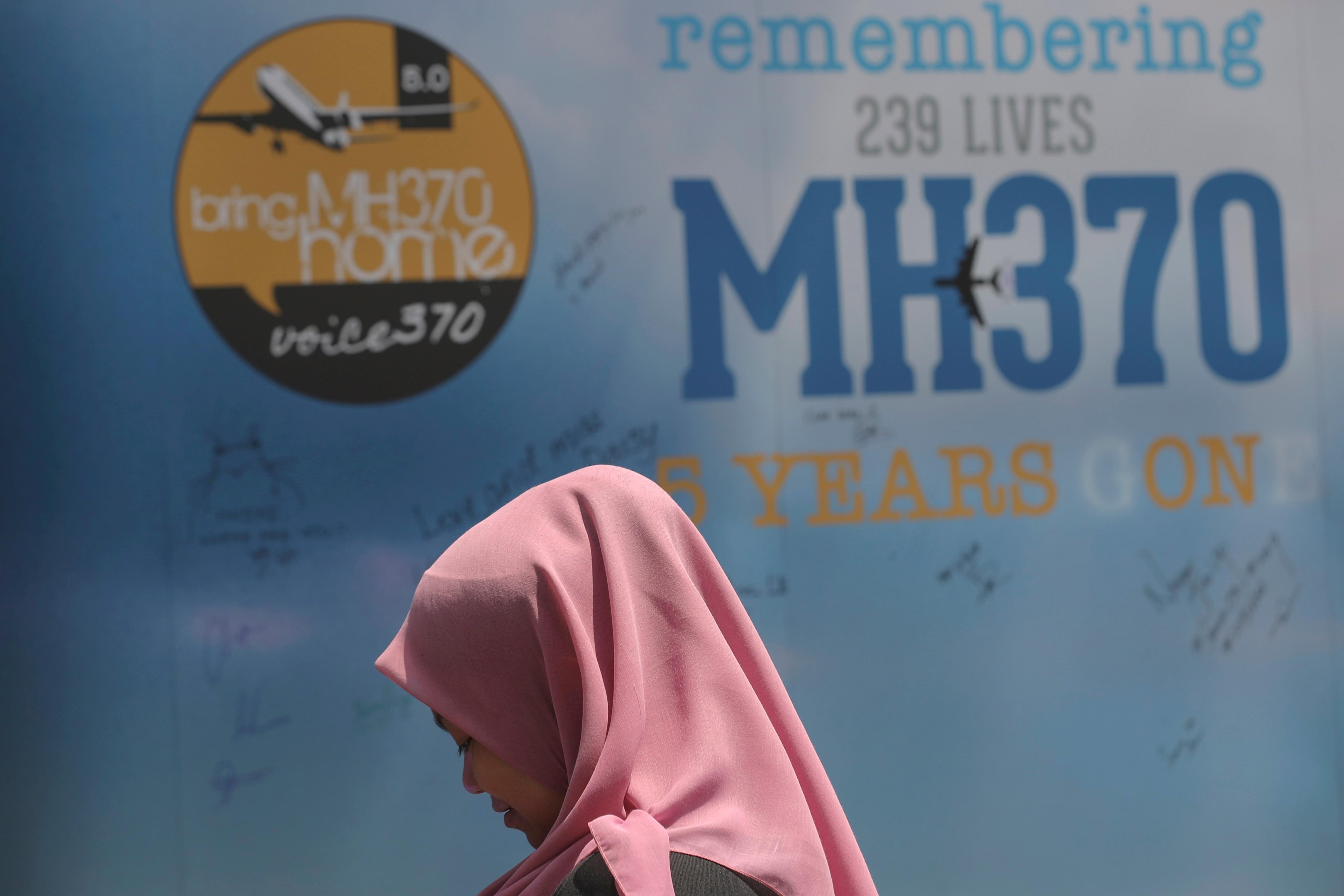 A girl stands in front of a condolence message board during a Day of Remembrance for MH370 event in Kuala Lumpur, Malaysia, on March 3, 2019.