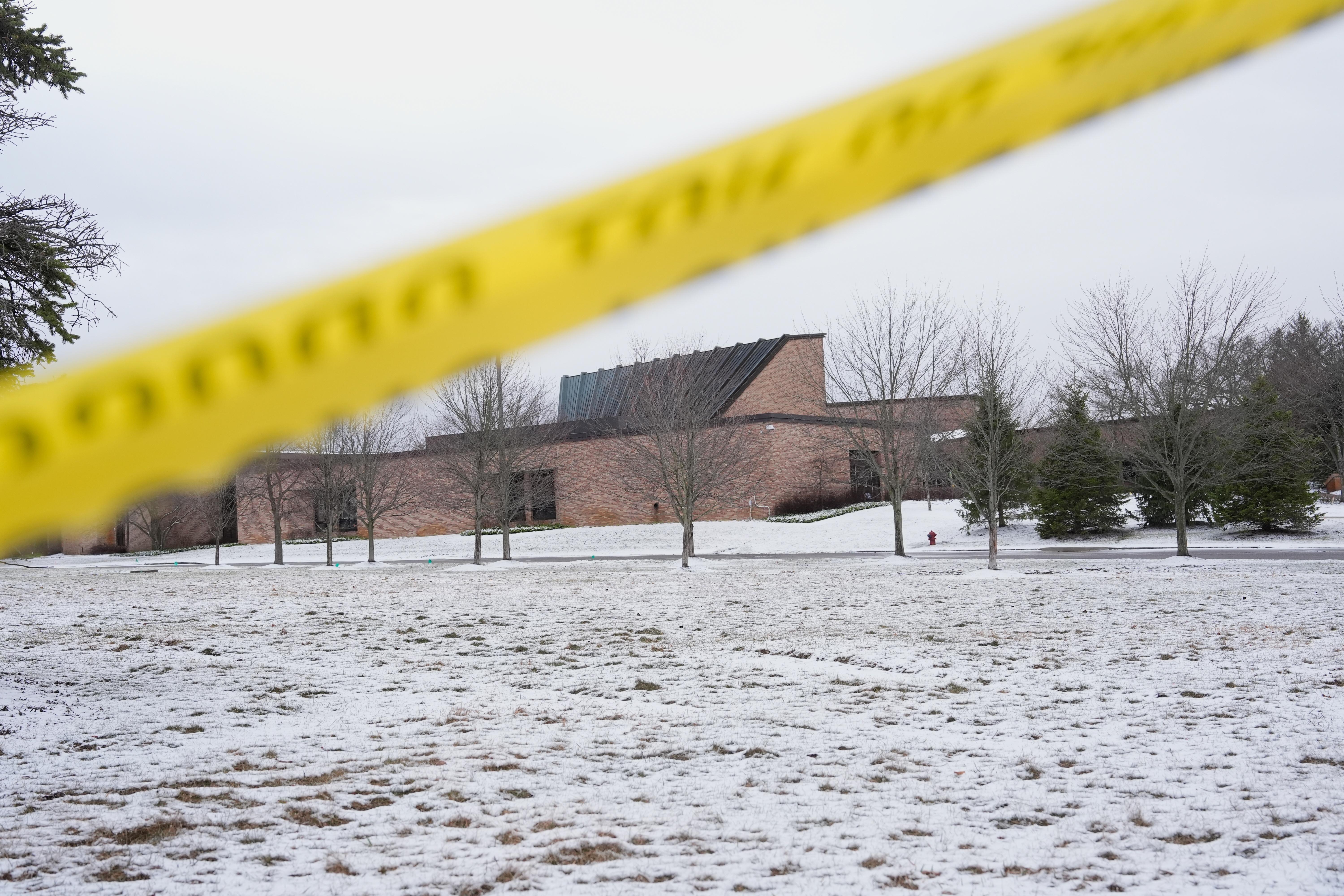 FILE - Police tape hangs outside the Temple Israel synagogue Friday, March 13, 2026, in West Bloomfield Township, Mich.