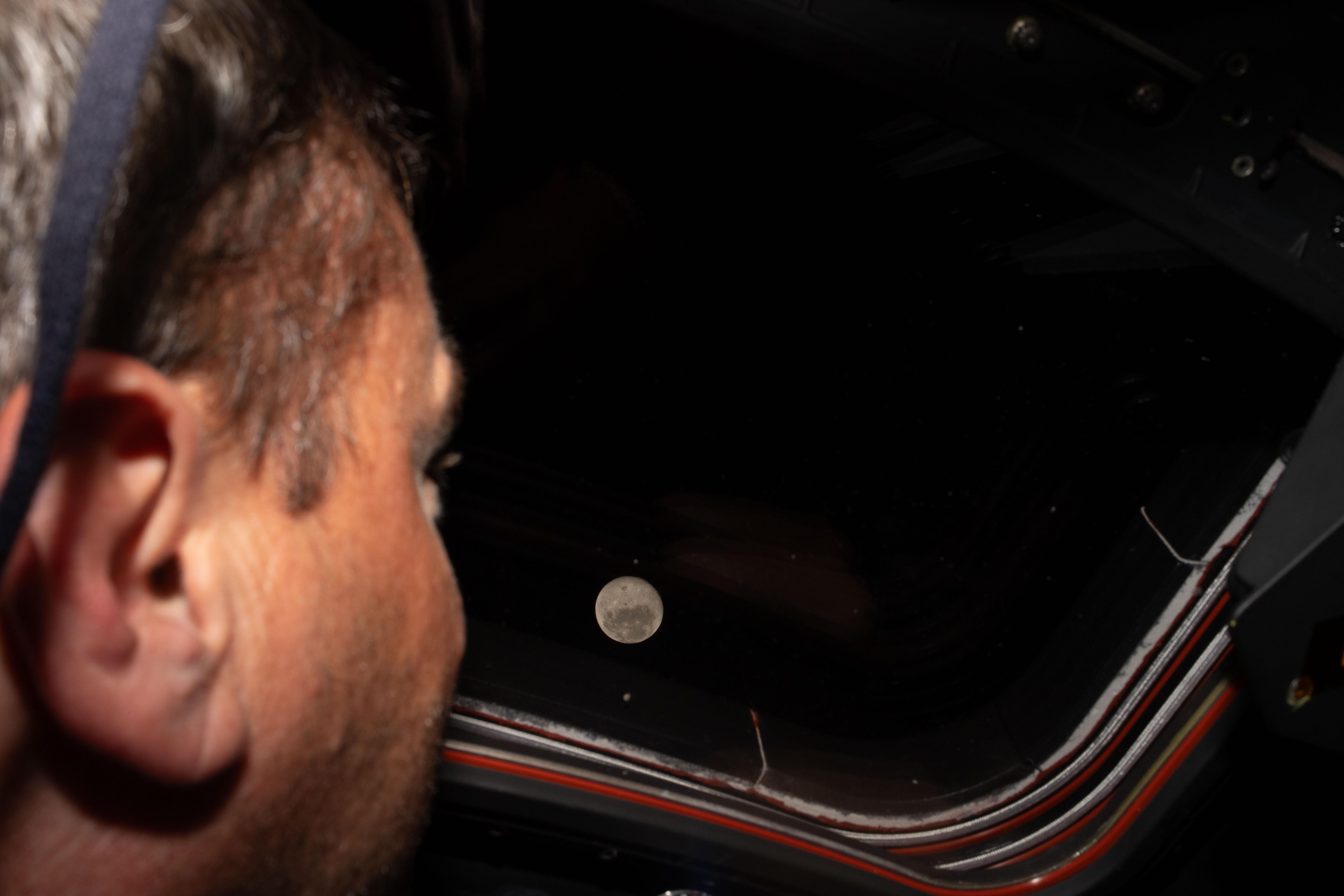 Artemis II commander Reid Wiseman looks out one of the Orion spacecraft