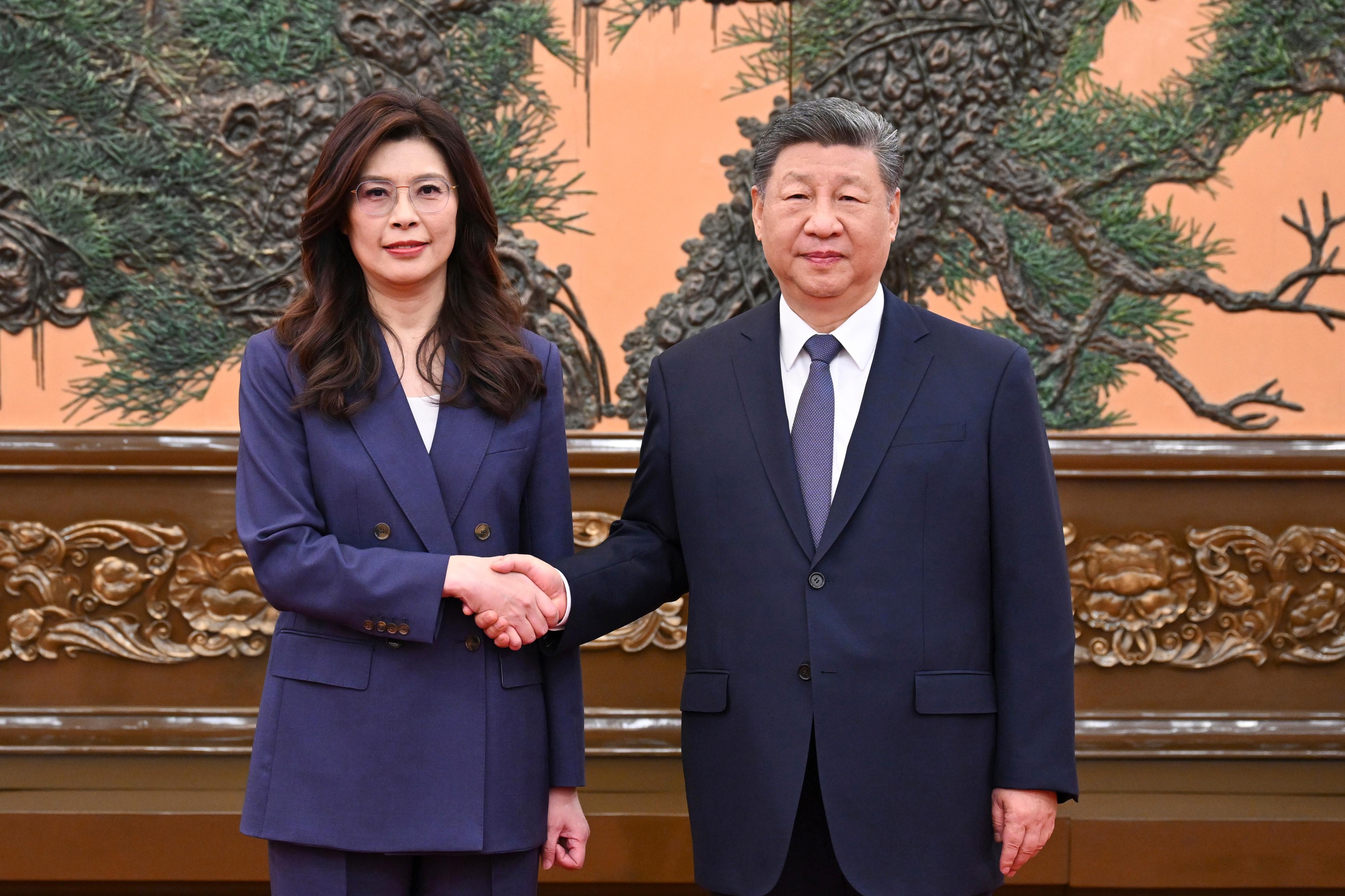 In this photo released by Xinhua News Agency, Chinese President Xi Jinping, right shakes hands with Kuomintang (KMT) party leader Cheng Li-wun in Beijing on Friday, April 10, 2026.