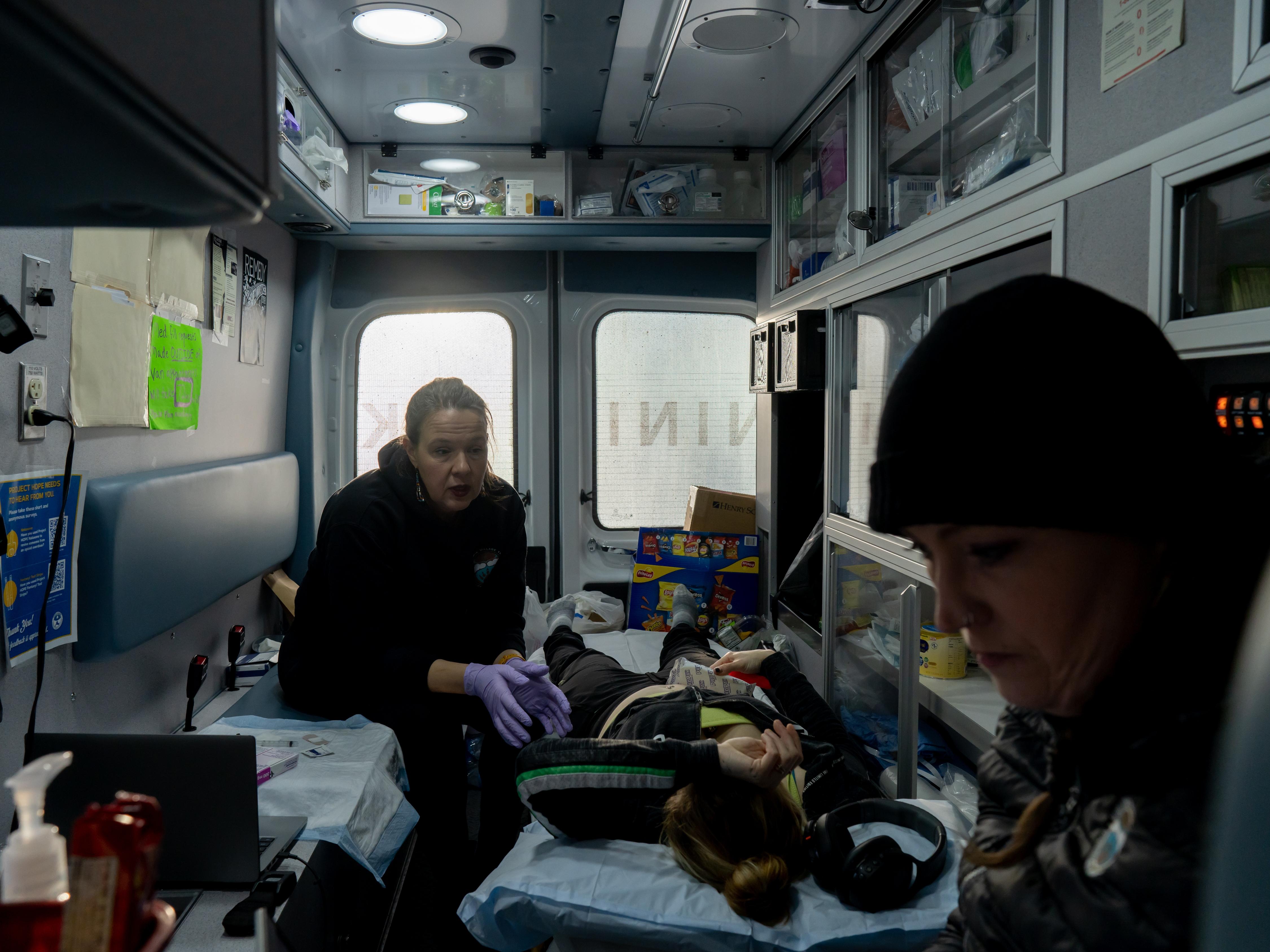 Dr. Sarah Spencer and Case Manager Annette Hubbard see a patient in the mobile clinic outside of a shelter in Kenai, Alaska on November 20, 2025.