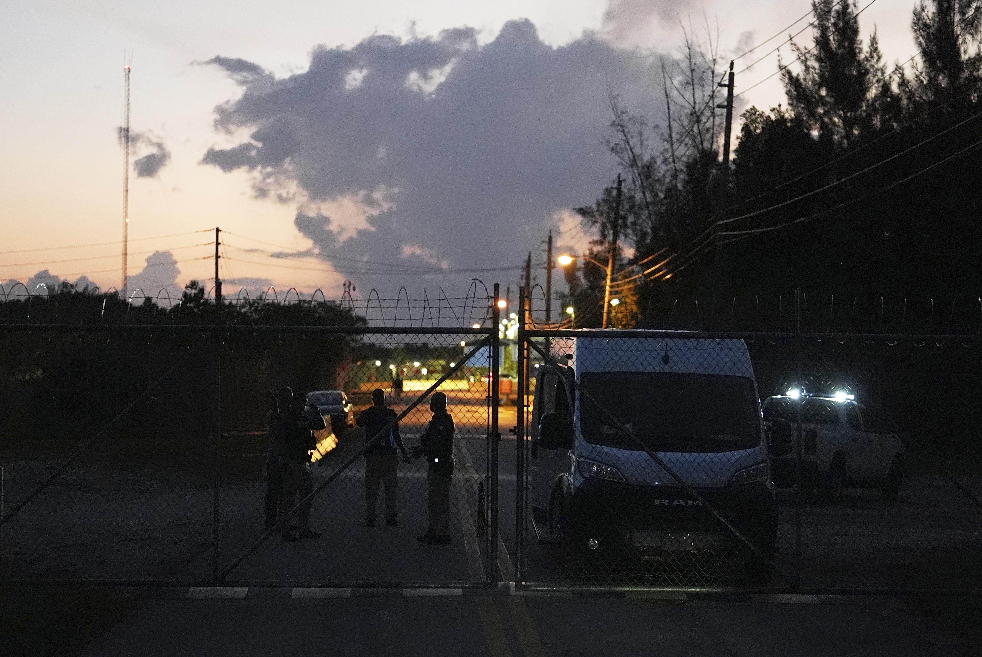 Krome Detention Center officers man a gate leading to the U.S. Immigration and Customs Enforcement facility, May 24, 2025, in Miami.