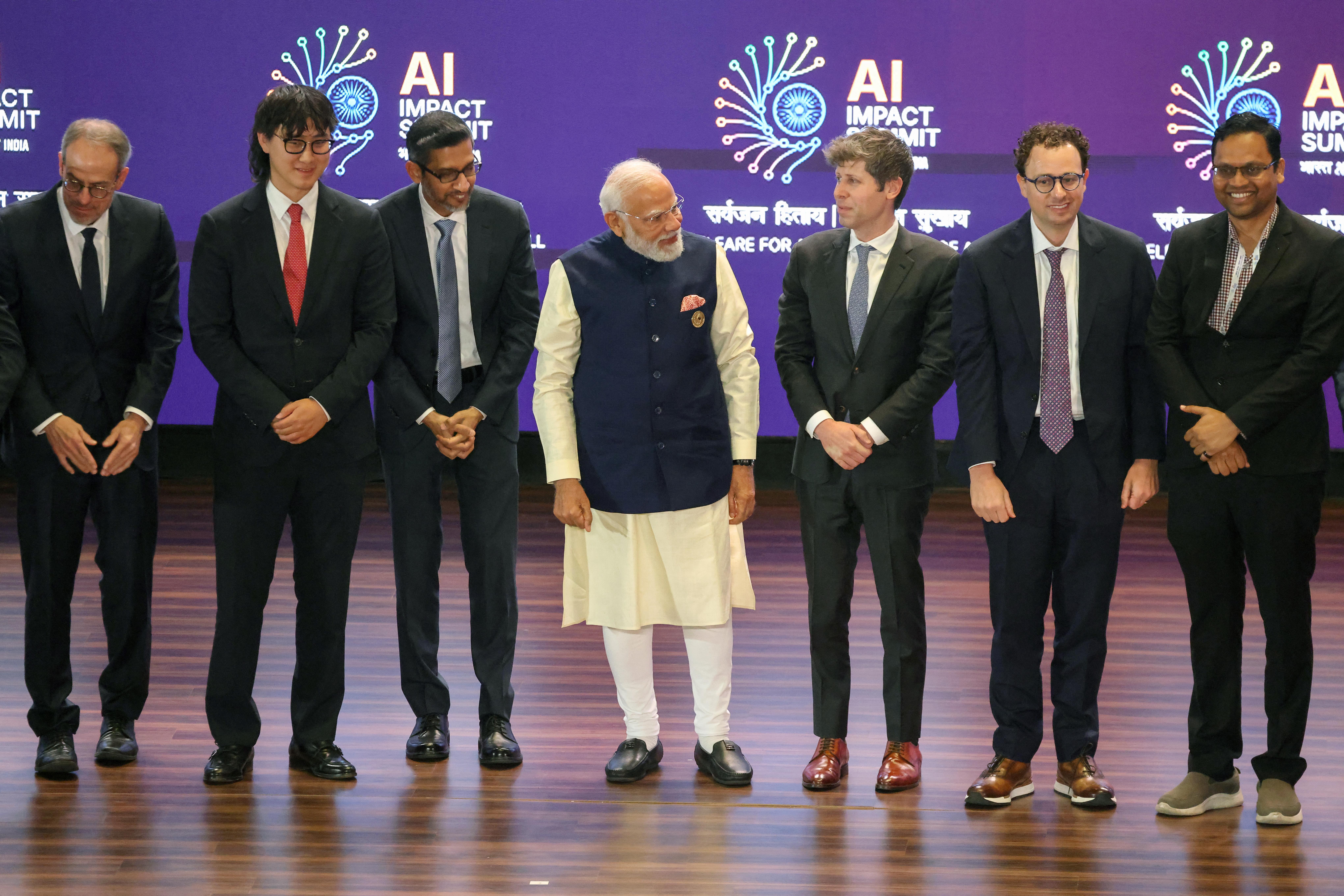 Indian Prime Minister Narendra Modi (center) takes a group photo with AI company leaders, including OpenAI CEO Sam Altman (third from right), Anthropic CEO Dario Amodei (second from right), Google CEO Sundar Pichai (third from left) and Meta Chief AI Officer Alexandr Wang (second from left), at the AI Impact Summit in New Delhi on Feb. 19.