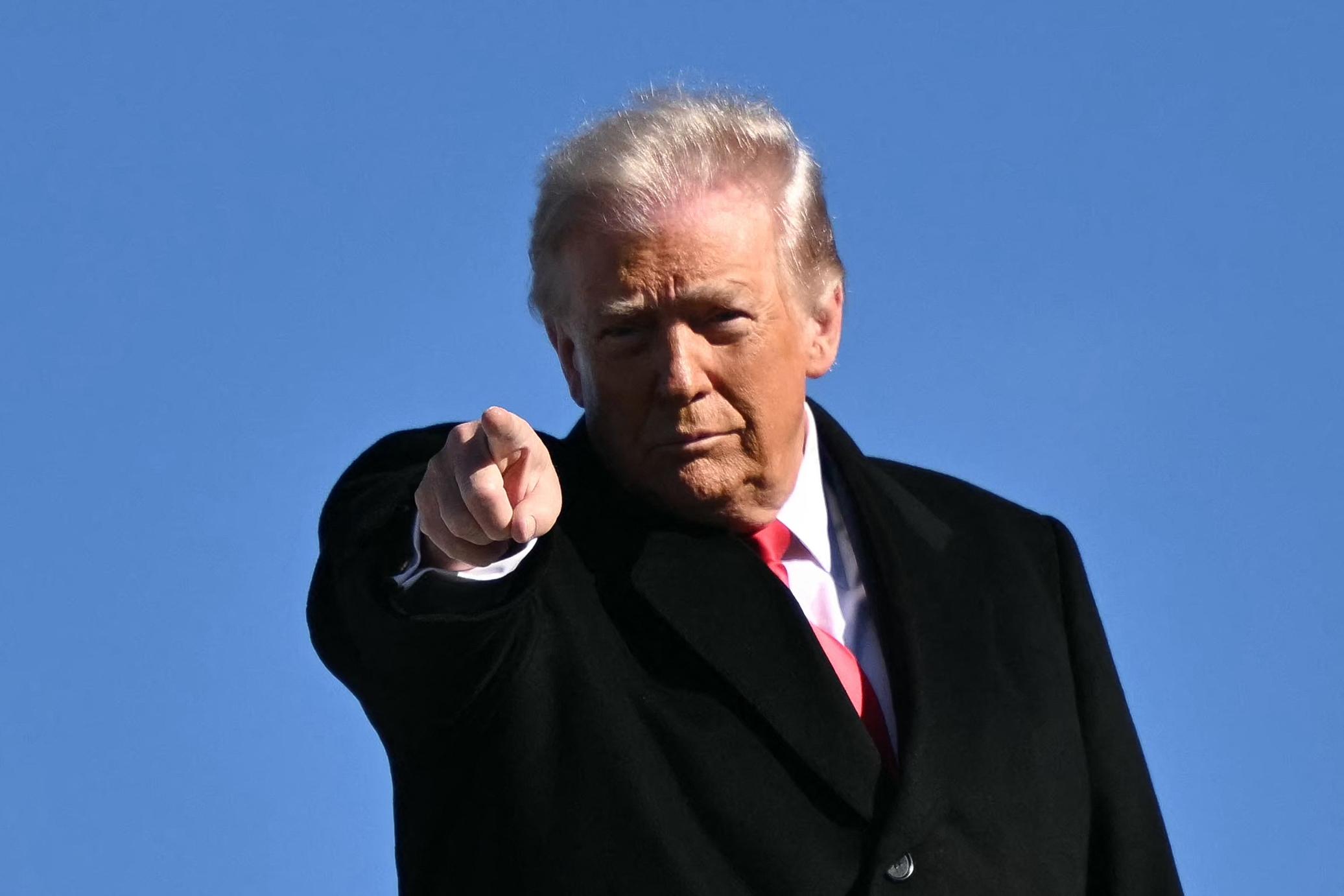 President Trump gestures as he boards Air Force One on Jan. 13.