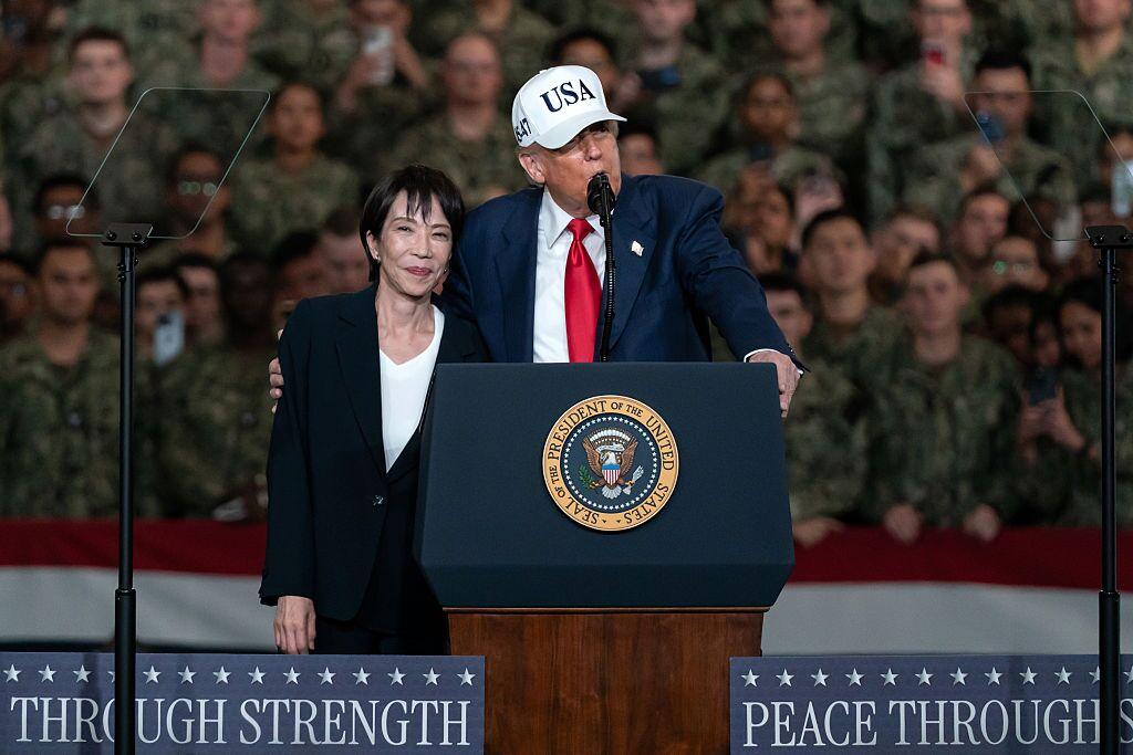 Japanese Prime Minister Sanae Takaichi (R) listens as U.S. President Donald Trump (L) speaks to troops aboard USS George Washington on October 28, 2025 in Yokosuka, Japan.