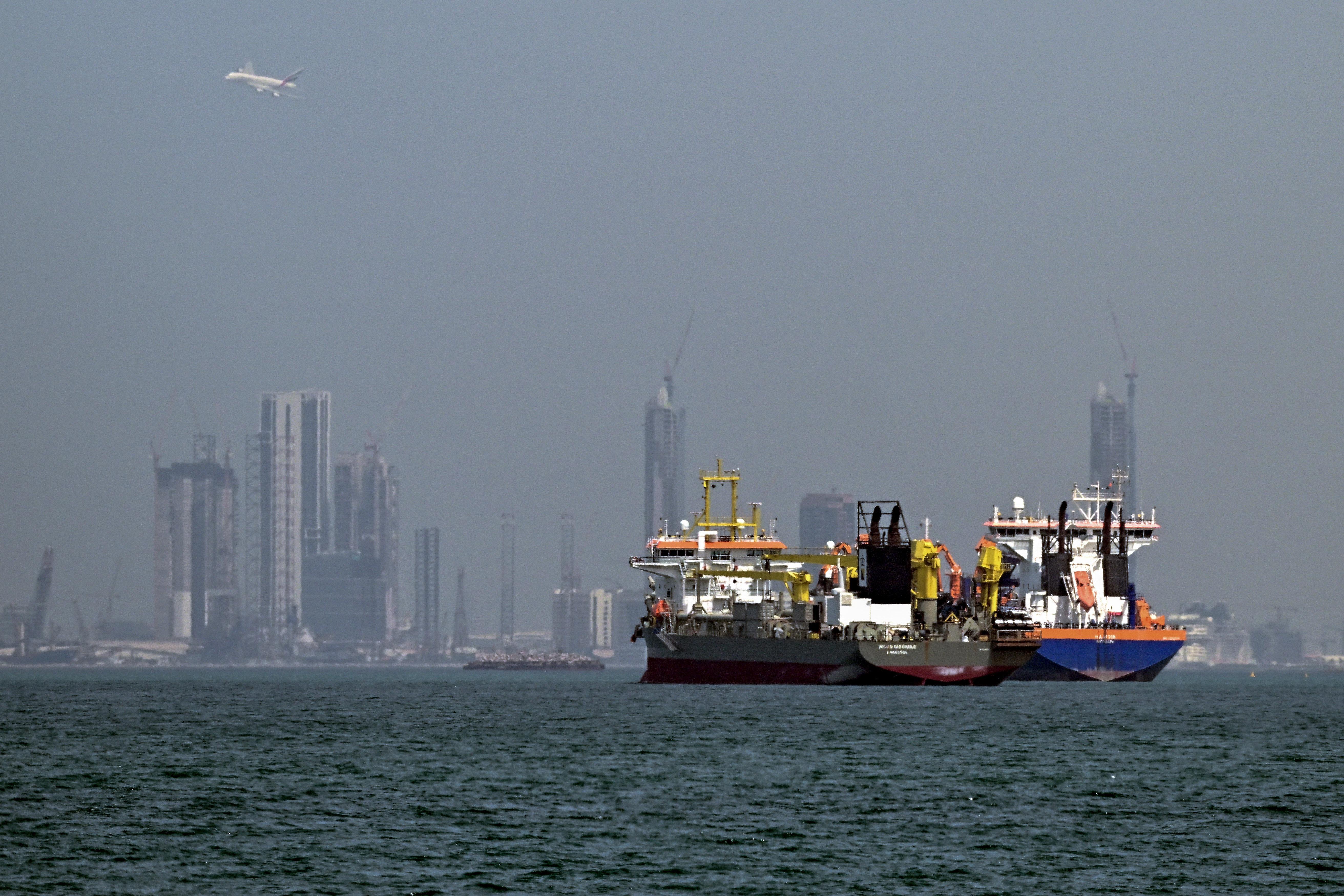 Commercial vessels offshore in Dubai, United Arab Emirates, on March 11. Attacks hit three commercial ships in the Gulf on March 11 as Iran pressed its campaign against its oil-exporting neighbors, threatening shipping in the Strait of Hormuz.