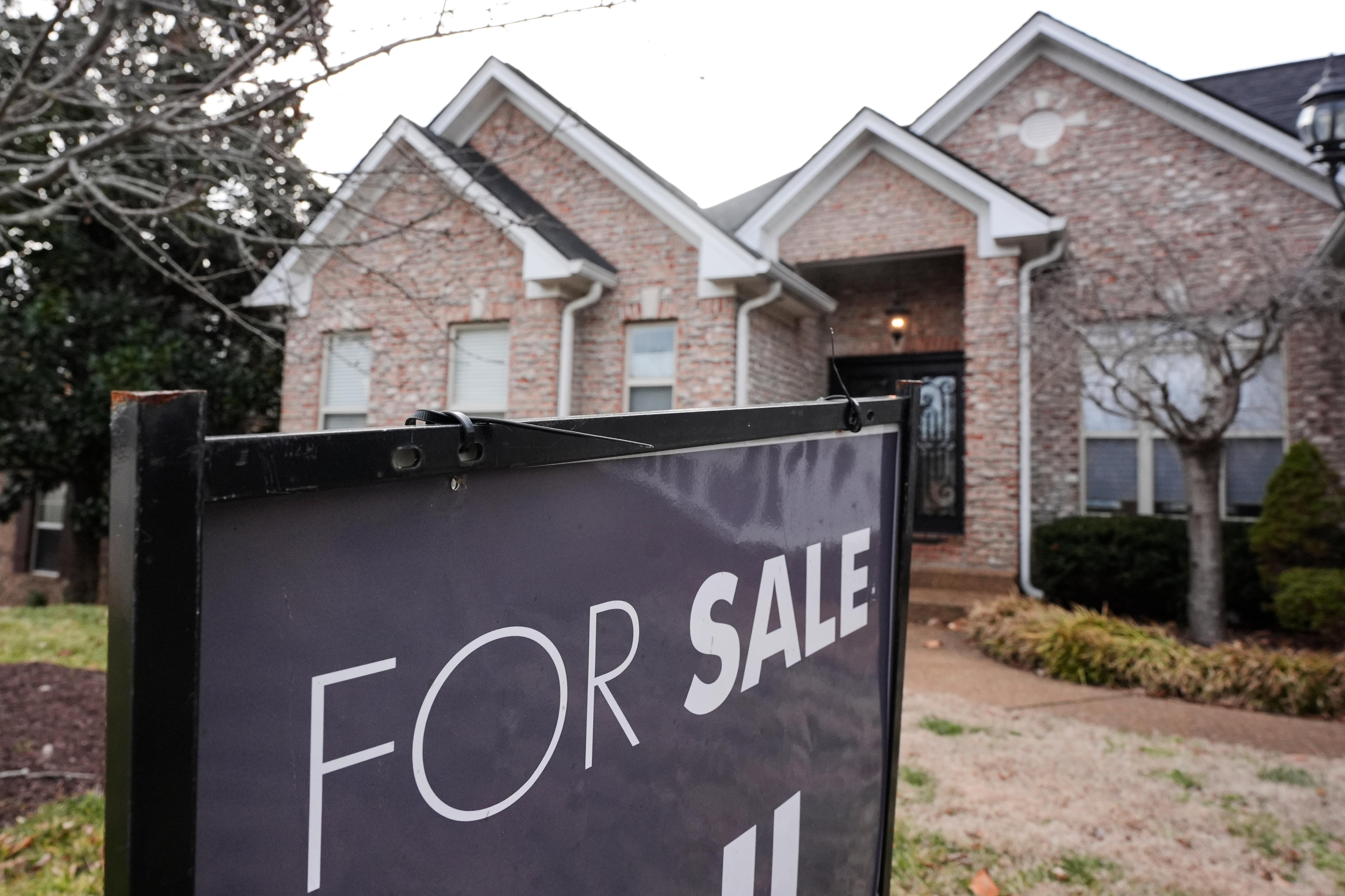 A for-sale sign stands outside a home in Nashville, Tenn., on Feb. 10.