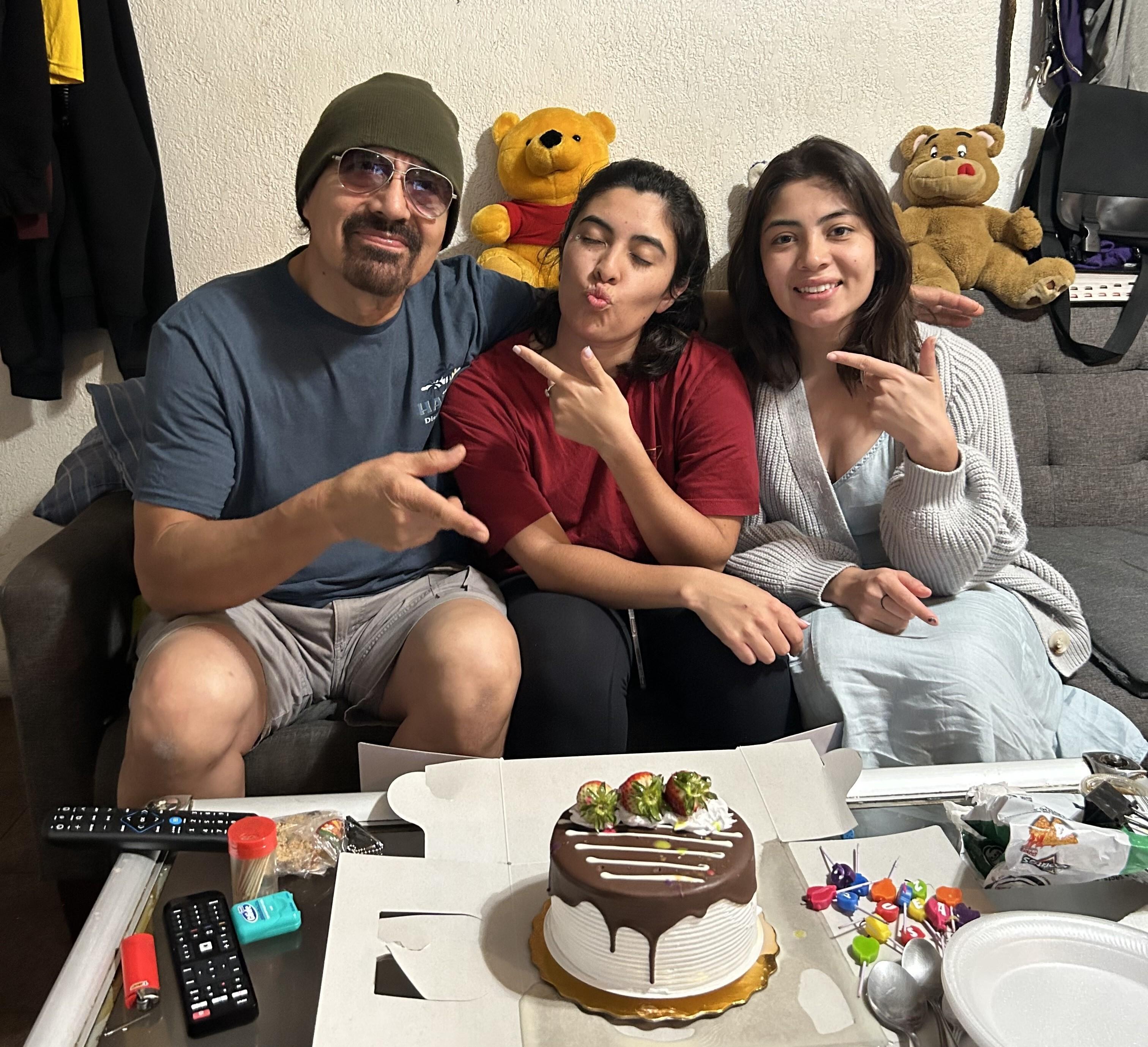Francisco Urizar celebrates his 64th birthday with his daughters Nancy (center) and Francis (right). Since her father was taken into Immigrations and Customs Enforcement custody earlier in the week, Nancy has been frantically searching for clues about where, and why, he has been detained.
