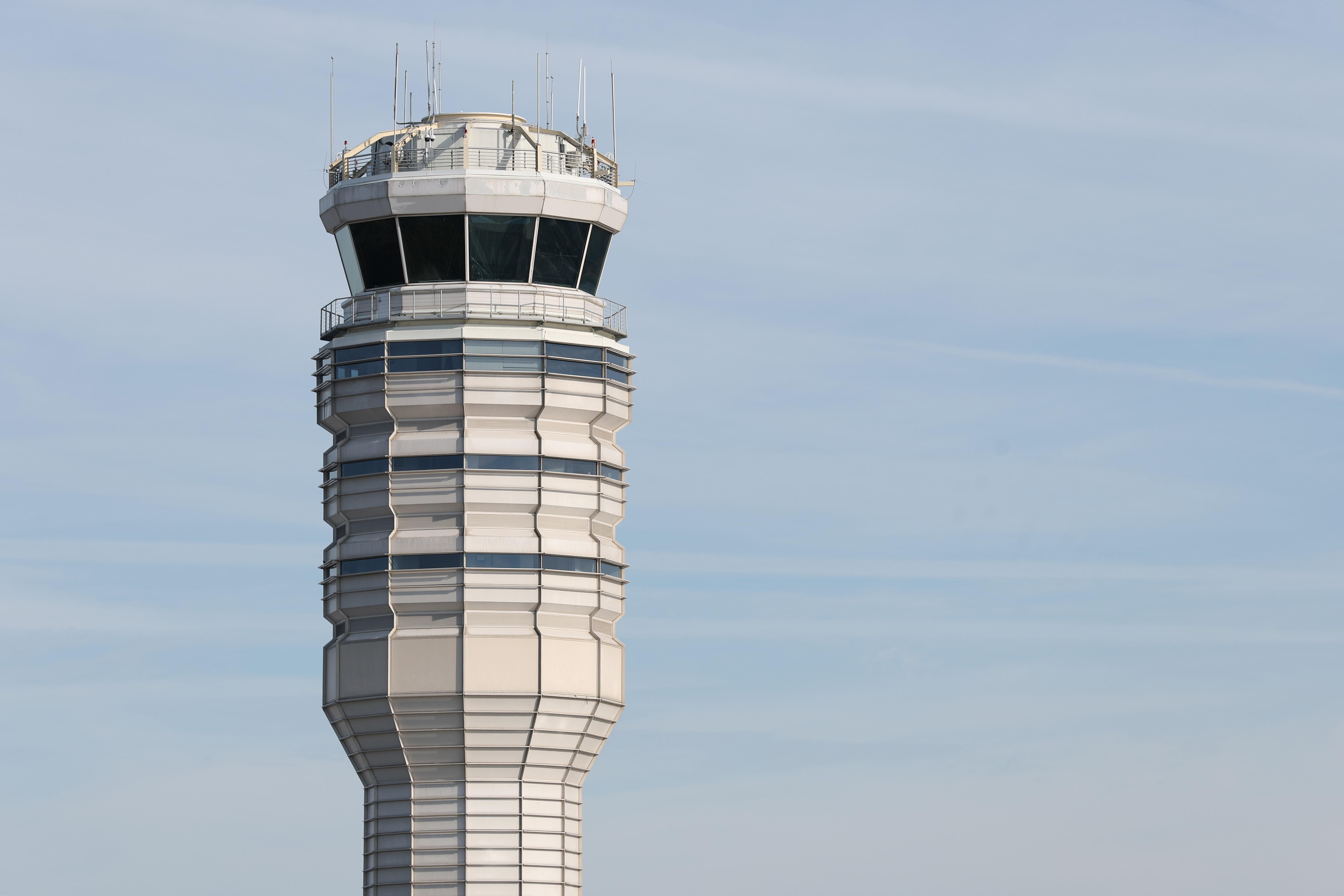 An air traffic control tower rises above Ronald Reagan Washington National Airport, one of the 40 major airports nationwide targeted for Federal Aviation Administration flight reductions..