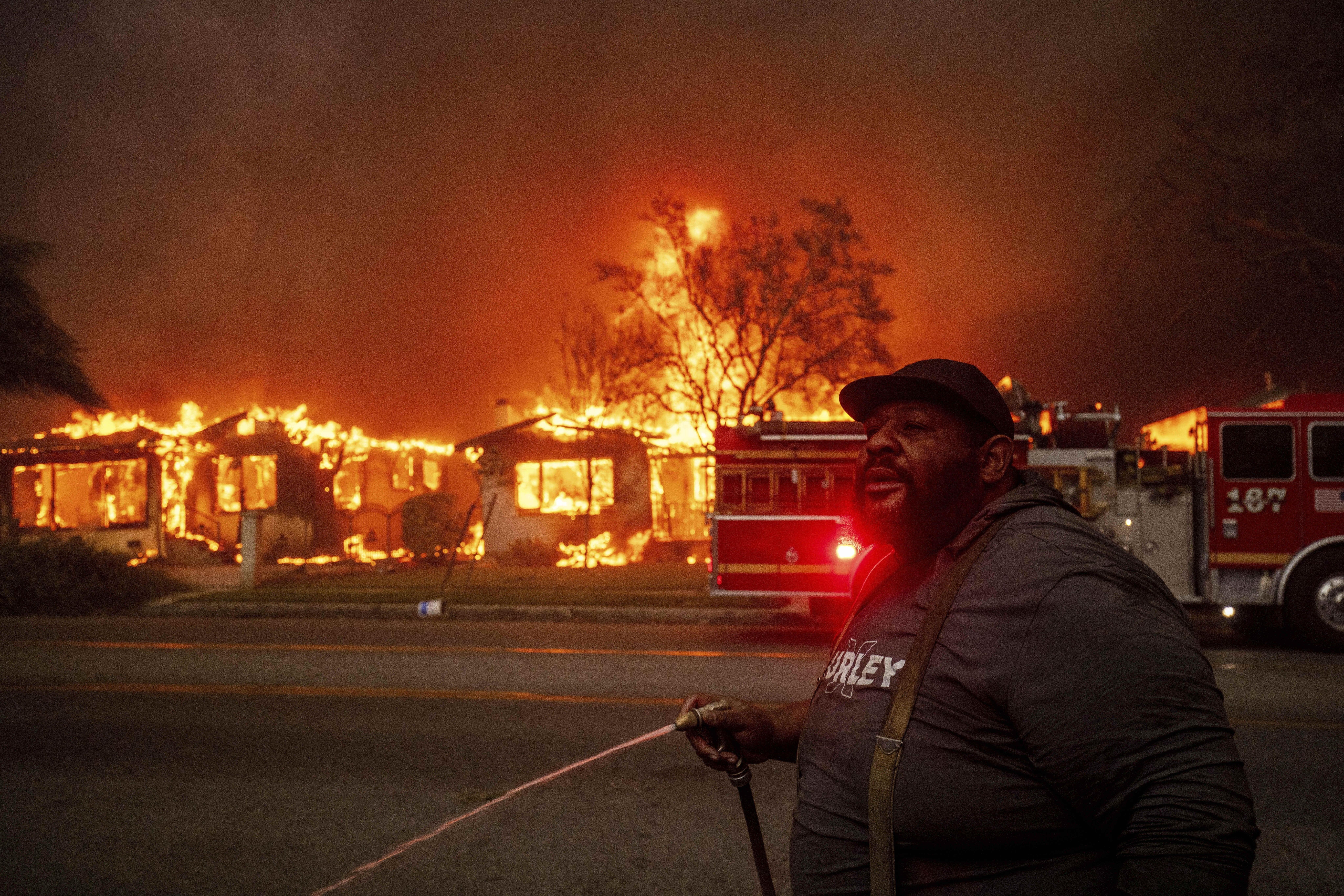 A resident of Altadena, Calif., during wildfires in January 2025. Wildfires are getting more extreme because of climate change. The Trump administration has taken down the website for the National Climate Assessment, which is the most comprehensive and authoritative source of information about how climate change is affecting all parts of the U.S.