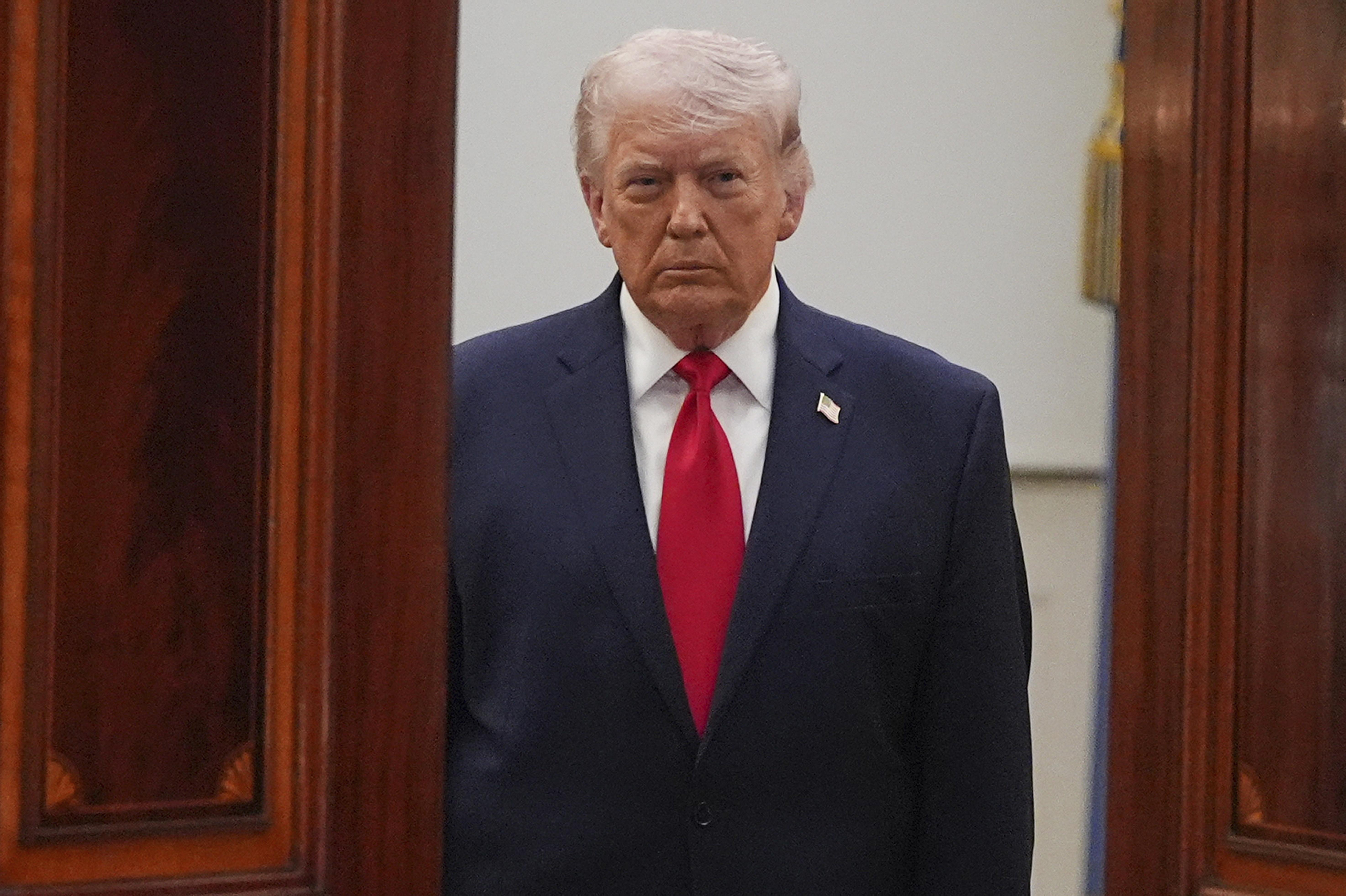 President Donald Trump arrives from the Blue Room to speak about the Iran war from the Cross Hall of the White House on April 1.