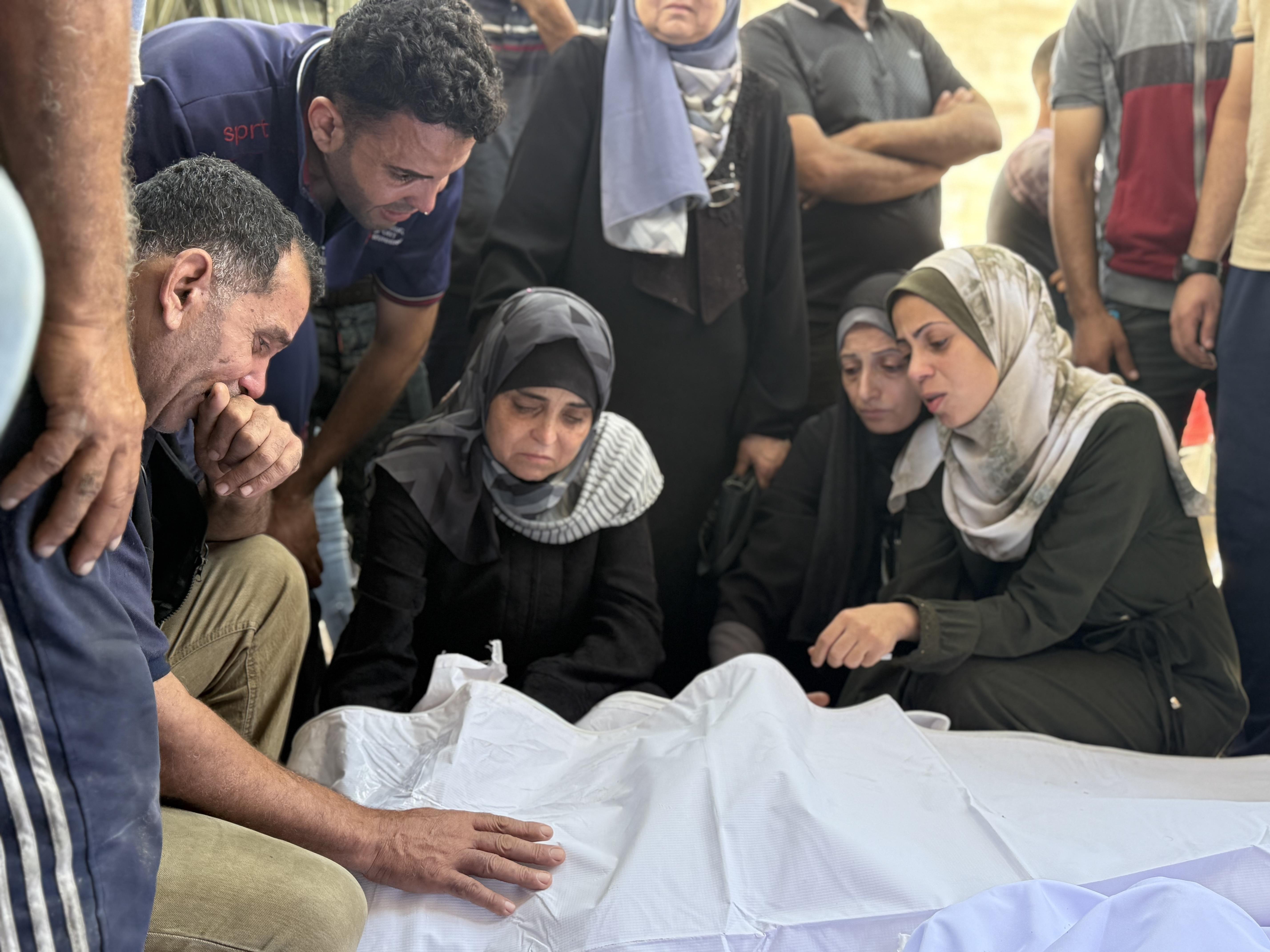 Relatives grieve over bodies of family members killed in an Israeli strike on a school sheltering displaced Palestinians near al-Shifa hospital in Gaza City on Thursday.