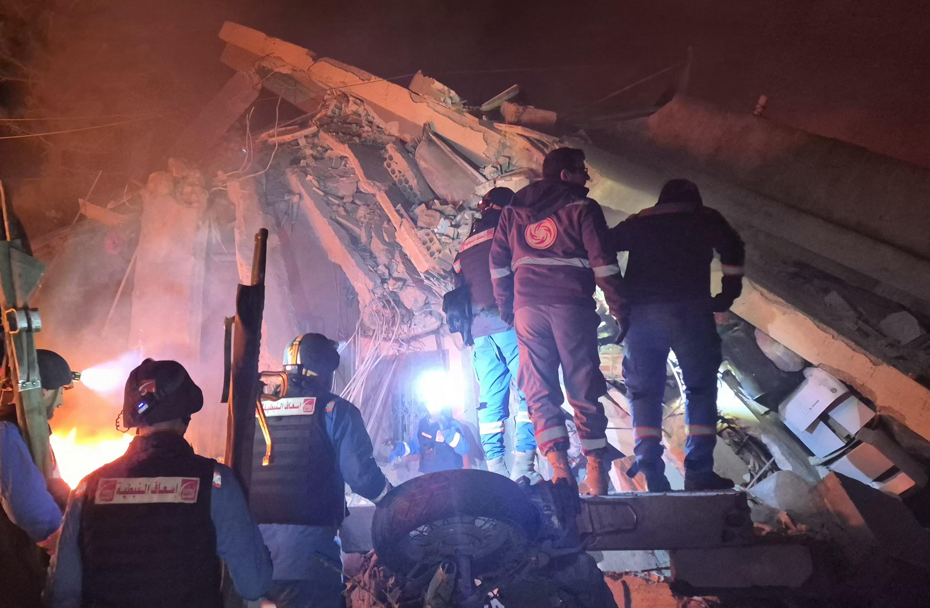 First responders search under the rubble at the site of an Israeli airstrike in the village of Habbouch, southern Lebanon on April 10, 2026.