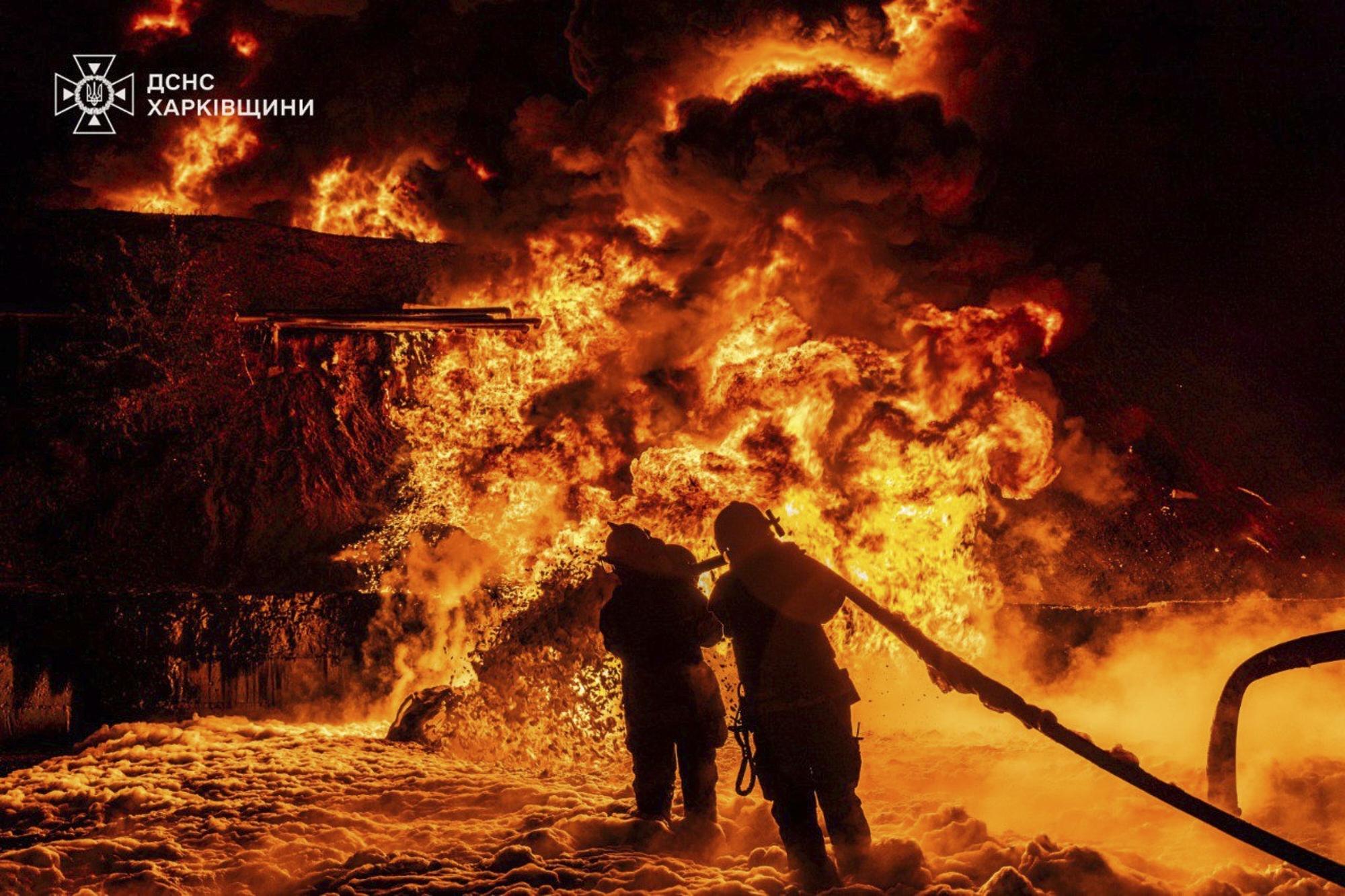 In this photo provided by the Ukrainian Emergency Service, emergency services personnel work to extinguish a fire following a Russian attack in Kharkiv region, Ukraine, Saturday, July 5, 2025.