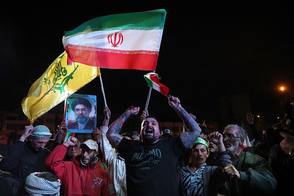 Iranians react after a ceasefire announcement at the Enqelab square, in Tehran, on April 8 2026.
