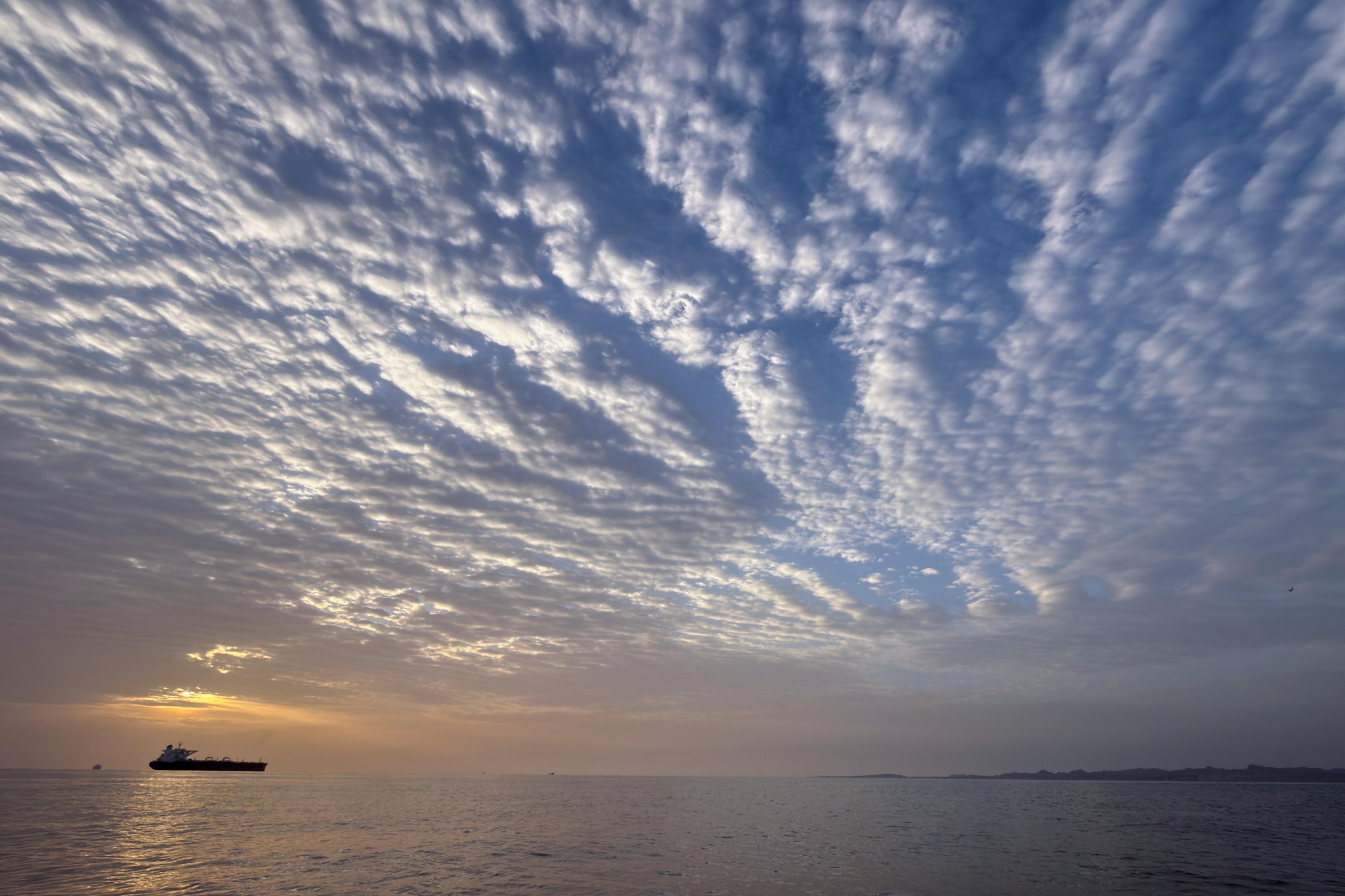 The sun rises behind a tanker anchored in the Strait of Hormuz off the coast of Qeshm Island, Iran, on Saturday.