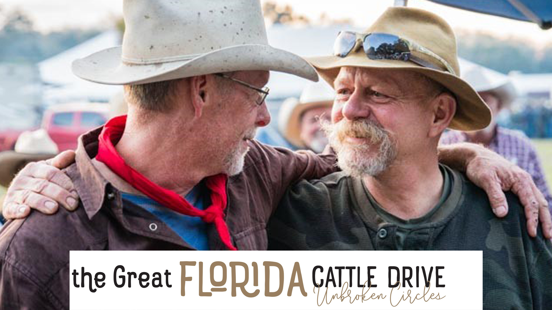 A veteran and a man who drove a wagon for the Great Florida Cattle Drive 2016 smile at each other.