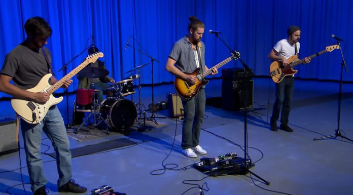Taller Trees | “Old as Earth” People playing instruments on stage