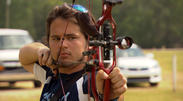 The William Tell of Cairo, GA Person prepares to shoot bow and arrow
