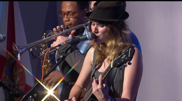 Rachel Hillman sings “The Times They Are A Changin’” Rachel Hillman sings on stage while musician plays trumpet