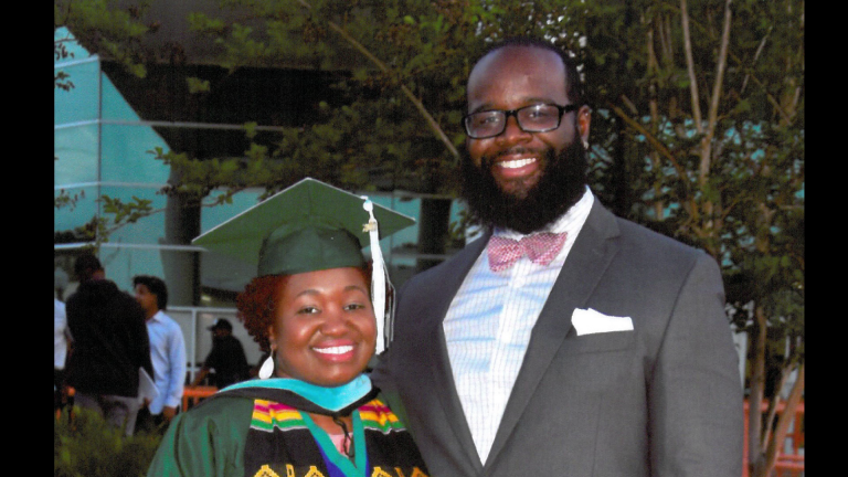 A FAMU Love Story Man smiles with a recent graduate of FAMU