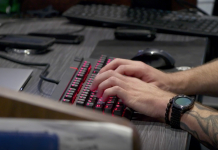 Apprenticeships Allow You to Learn & Earn on Your Way to a New Career hands typing on black backlit keyboard