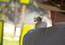 Cowboy action Shooting! Cowboy aiming pistol at targets