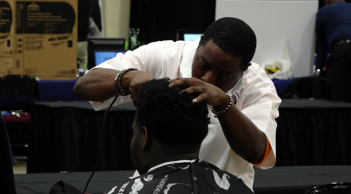 Exploring the 2019 Leon Works Expo Barber shaves a mans head