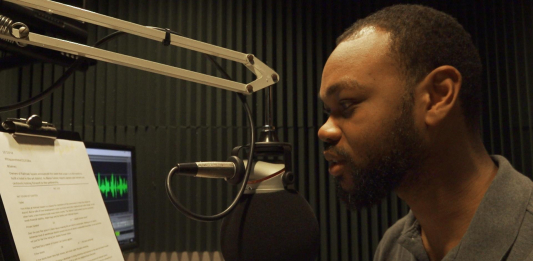 Man on radio talk show talks into microphone to inform listeners on how to prepare for approaching storm