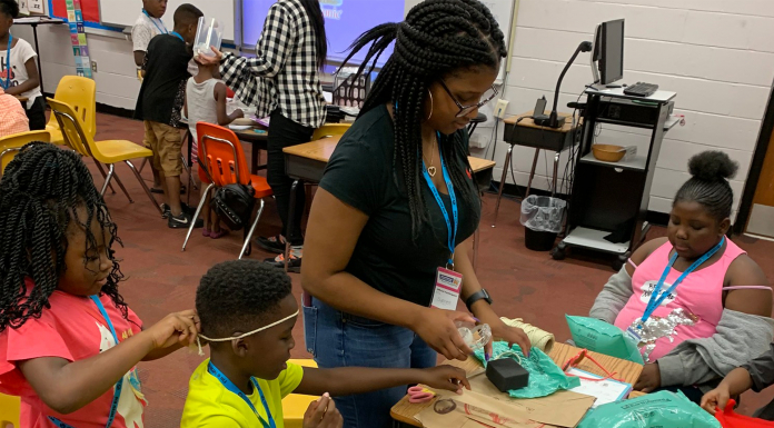 Internships and Careers: Learning What It Takes to Make it in the Real World Young woman standing at table surrounded by children working on a craft project.