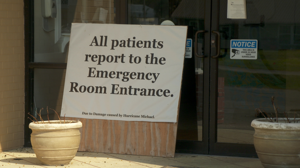 A sign in front of the Calhoun Liberty Hospital directs patients to use the Emergency Room Entrance around the side of the building.