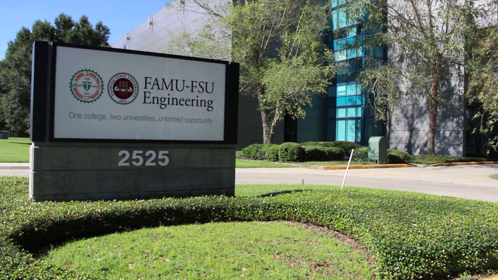 A sign sitting on the grass